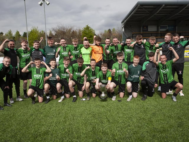 The St. Joseph’s Boys School squad and coaches celebrate sweet victory on Friday.