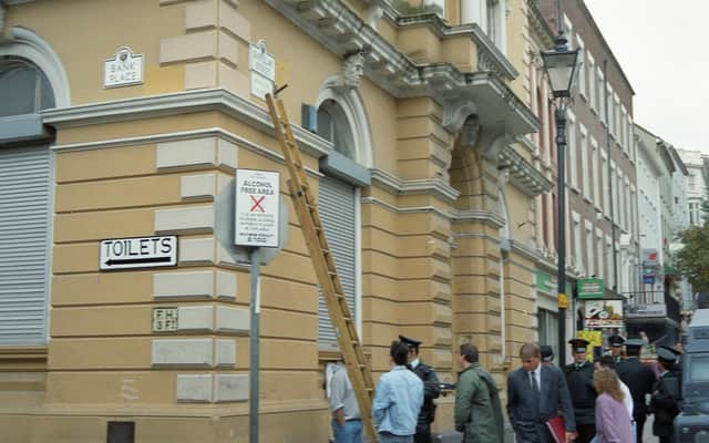 One of the first street signs in Irish being erected at Shipquay Street in 1992.