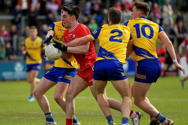 Derry’s Conor McCluskey battles with Roscommon trio Niall Higgins, David Murray and Dylan Ruane . Photo: George Sweeney