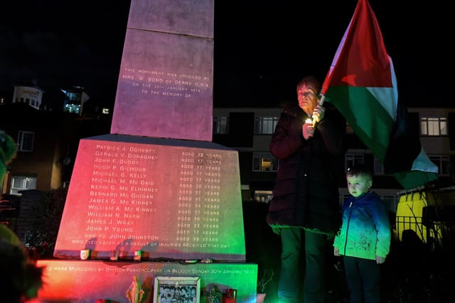 Participant holds a Palestinian flag at the procession and vigil for the children of Palestine at the Bloody Sunday Monument on Rossville Street. Photo: George Sweeney