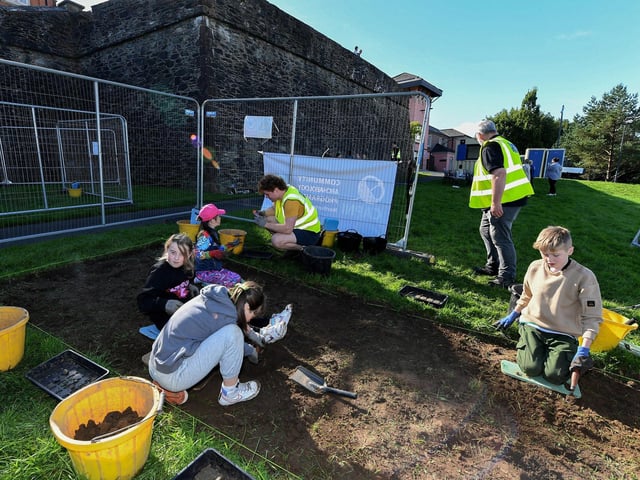 Gaelscoil Eadain Mhoir pupils pictured at the Queen's University Centre for Community Archaeology dig in an area beneath the City Walls. Photo: George Sweeney