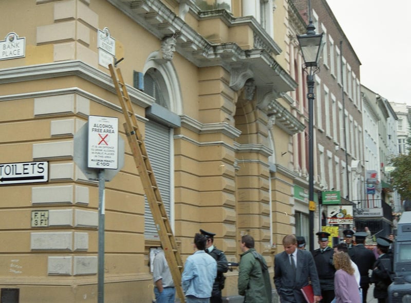 RUC officers arrive on the scene as the first city centre street signs in Irish are erected at Shipquay Street in 1992.