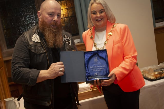 .The Mayor of Derry City and Strabane District Council, Sandra Duffy making a presentation to Kevin Kelly, The Outlaws Motorcycle Club at the Guildhall on Friday night in recognition of the club’s charity work in the city and district.:.