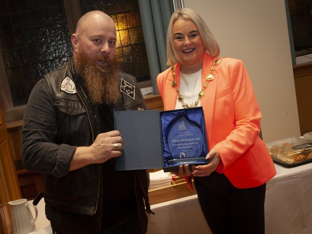 .The Mayor of Derry City and Strabane District Council, Sandra Duffy making a presentation to Kevin Kelly, The Outlaws Motorcycle Club at the Guildhall on Friday night in recognition of the club’s charity work in the city and district.:.