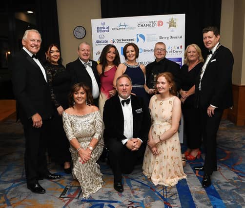 Winners of the main award of the night, the Brilliance In Business Award, Millennium Forum, alongside Ian Crowe and Greg McCann
