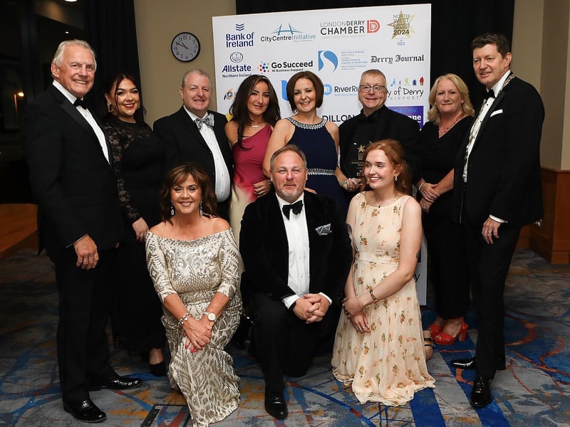 Winners of the main award of the night, the Brilliance In Business Award, Millennium Forum, alongside Ian Crowe and Greg McCann