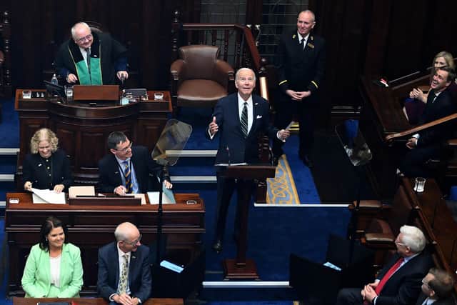 TOPSHOT - US President Joe Biden (C) reacts as he arrives to deliver a speech at the Dail Eireann, the lower house of the Irish Parliament, at Leinster House in Dublin, on April 13, 2023, during his four day trip to Northern Ireland and Ireland. (Photo by Jim WATSON / AFP) (Photo by JIM WATSON/AFP via Getty Images)