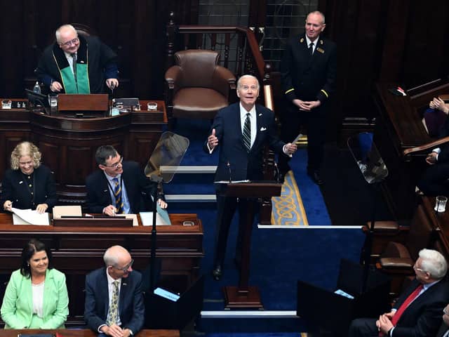 TOPSHOT - US President Joe Biden (C) reacts as he arrives to deliver a speech at the Dail Eireann, the lower house of the Irish Parliament, at Leinster House in Dublin, on April 13, 2023, during his four day trip to Northern Ireland and Ireland. (Photo by Jim WATSON / AFP) (Photo by JIM WATSON/AFP via Getty Images)