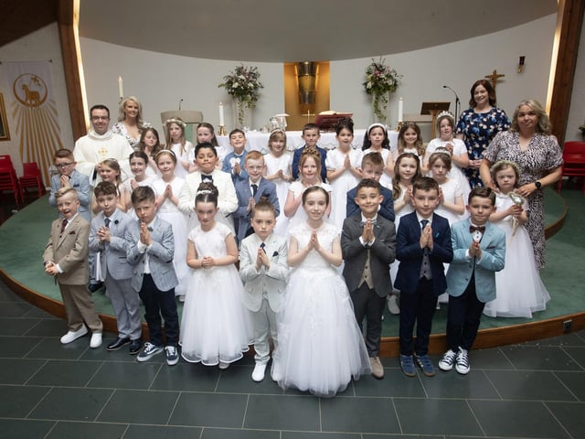 Children from Mrs. McAllister's class at Sacred Heart PS who received the Sacrament of First Holy Communion from Fr. Patrick Lagan at Sacred Heart Church on Saturday last. Included are Kiera and Deborah, classroom assistants. (Photo: Jim McCafferty Photography)