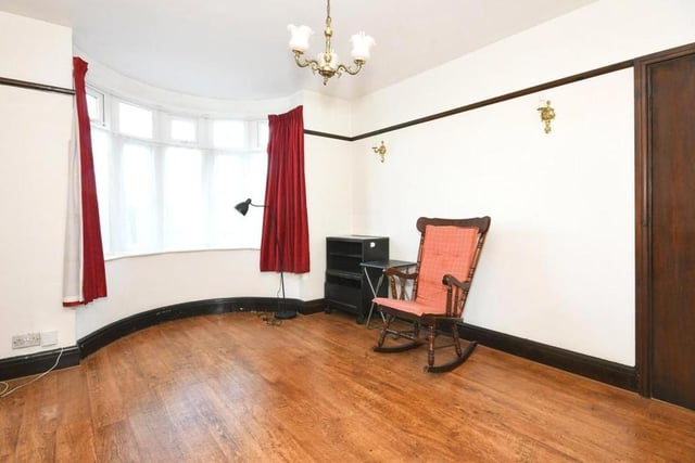 The reception room, or sitting room, is the one that looks out on to the front of the house from its bay windows.