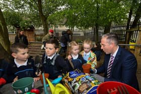 Education Minister Paul Givan pictured in the Rang 1 garden with pupils during his visit to the  Naíscoil Dhoire and Bunscoil Cholmcille, Steelstown, on Wednesday morning. Photo: George Sweeney