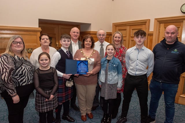 Twelve years old Jacob Laird from Bready Ulster Scots Pipe Band has been recognised by the Mayor Councillor Patricia Logue after he was crowned Ulster, All Ireland and World Champion solo snare drum champion. Pictured with Jacob are his mum and dad, Tanya and Ivor and grand parents Ann and Kenneth Scott and sisters Eve and Zara and brother Zac, with tutors Lee Lawson and Richard Campbell, leading Drum Sergeant. Picture Martin McKeown.