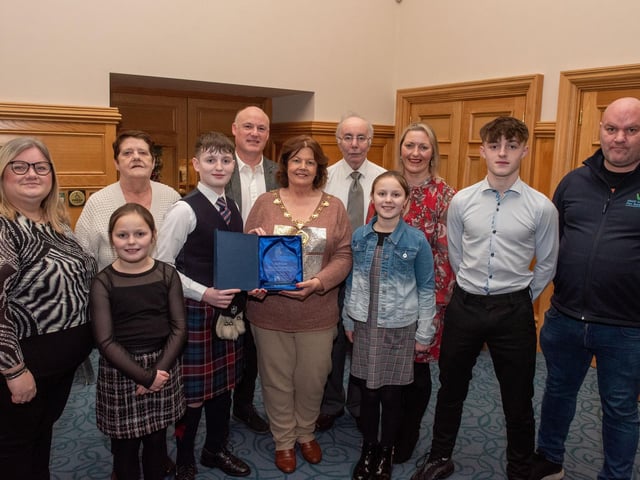 Twelve years old Jacob Laird from Bready Ulster Scots Pipe Band has been recognised by the Mayor Councillor Patricia Logue after he was crowned Ulster, All Ireland and World Champion solo snare drum champion. Pictured with Jacob are his mum and dad, Tanya and Ivor and grand parents Ann and Kenneth Scott and sisters Eve and Zara and brother Zac, with tutors Lee Lawson and Richard Campbell, leading Drum Sergeant. Picture Martin McKeown.