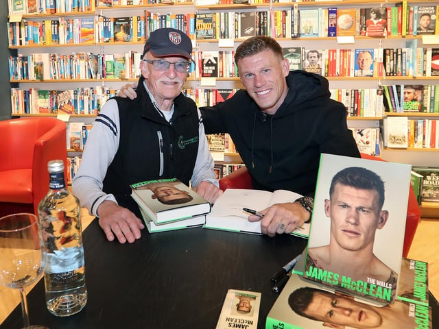 Professional footballer James McClean signing his autobiography, “The Walls” in Waterstones, Foyleside, for former professional football and former Derry City manager, Tony O'Doherty.