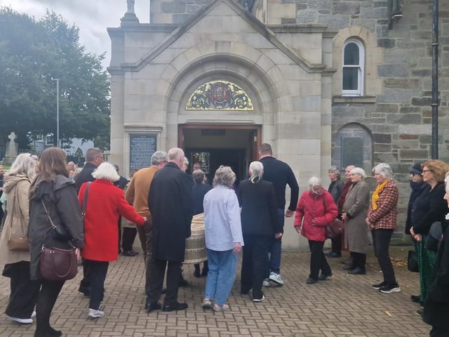 Nell McCafferty's casket is carried into the Long Tower on Friday.
