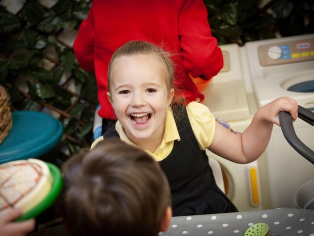 Primary 1 pupils Vivien has a big smile for the camera.:.
