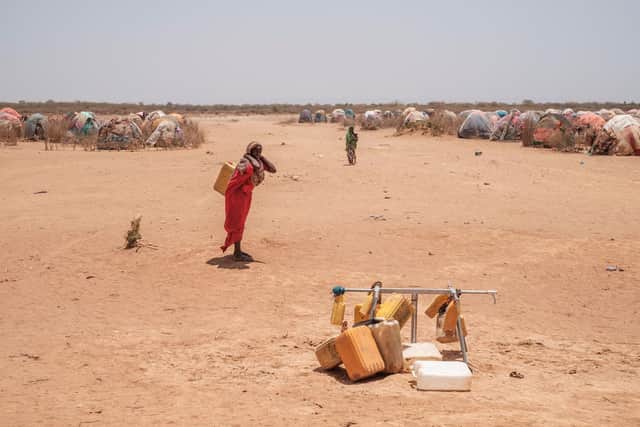 A woman stands next  to water taps that are out of service in the camp for internally displaced people of Farburo 2 in the village of Adlale, near the city of Gode, Ethiopia, on April 6, 2022. (Photo by EDUARDO SOTERAS / AFP) (Photo by EDUARDO SOTERAS/AFP via Getty Images)