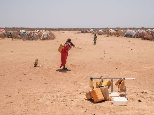 A woman stands next  to water taps that are out of service in the camp for internally displaced people of Farburo 2 in the village of Adlale, near the city of Gode, Ethiopia, on April 6, 2022. (Photo by EDUARDO SOTERAS / AFP) (Photo by EDUARDO SOTERAS/AFP via Getty Images)