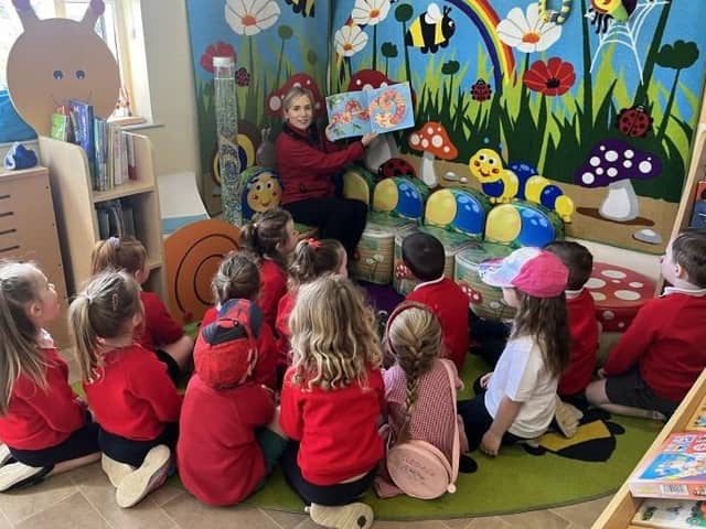Natalie McCloskey reading to children in Banagher Community Playgroup