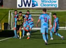 Institute’s Shaun Doherty gets the ball before H&W Welders’ Matthew Ferguson.