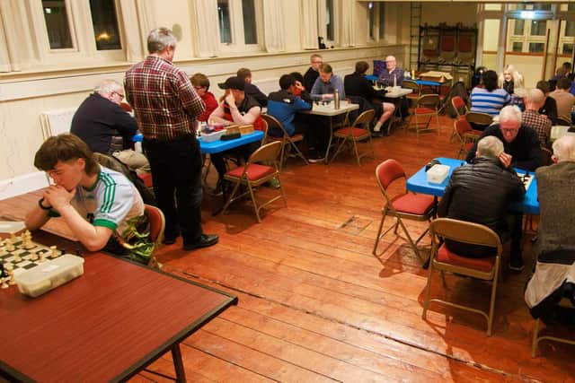 City of Derry Chess Club members focusing intently.