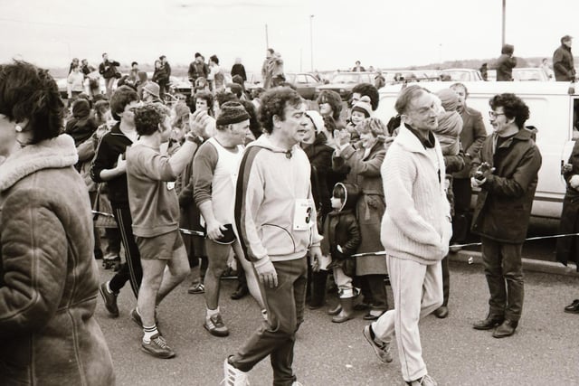 These runners work the crowd ahead of the start of the Male Mini Marathon in December 1983.
