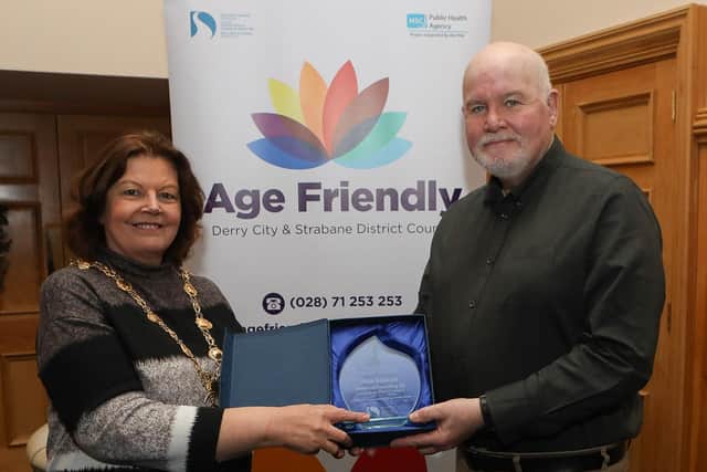 Mayor Patricia Logue makes a presentation to Peter Davidson, 2nd place in the Age Friendly "Your Happy Place" competition. (Photo - Tom Heaney, nwpresspics)
