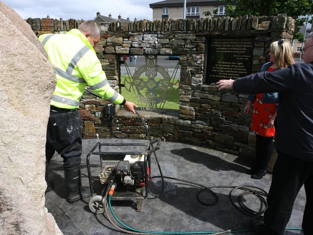 Councillors Tony Hassan and Sandra Duffy survey damage at the Republican monument outside Shantallow shops. DER2714MC090