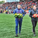 Derry City manager Ruaidhri Higgins and Treaty United boss Tommy Barrett lay a wreath in memory of the 10 people who lost their lives in Creeslough.
