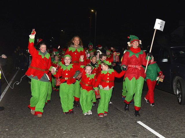 Culmore Community Partnership Elf Parade makes its way towards the Community Hub on Friday night. Photo: George Sweeney