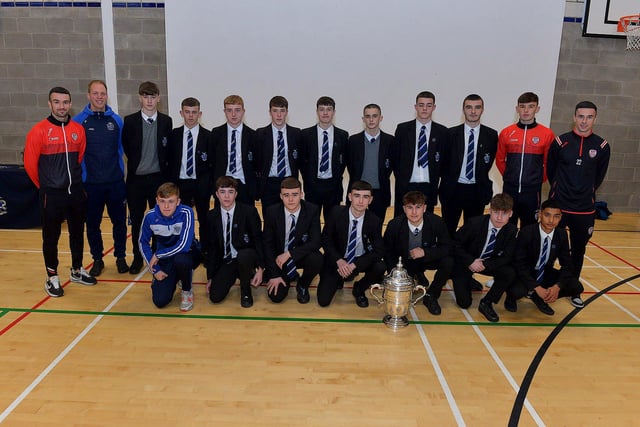 Derry City players Michael Duffy, Liam Mullan and Jordon McEneff pictured with St Columb's College Year 11 pupils and PE teacher James Green during a visit to the school, with the FAI Cup, on Monday. Photo: George Sweeney. DER2247GS - 25