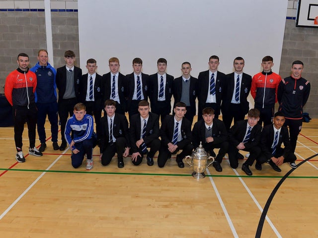 Derry City players Michael Duffy, Liam Mullan and Jordon McEneff pictured with St Columb's College Year 11 pupils and PE teacher James Green during a visit to the school, with the FAI Cup, on Monday. Photo: George Sweeney. DER2247GS - 25