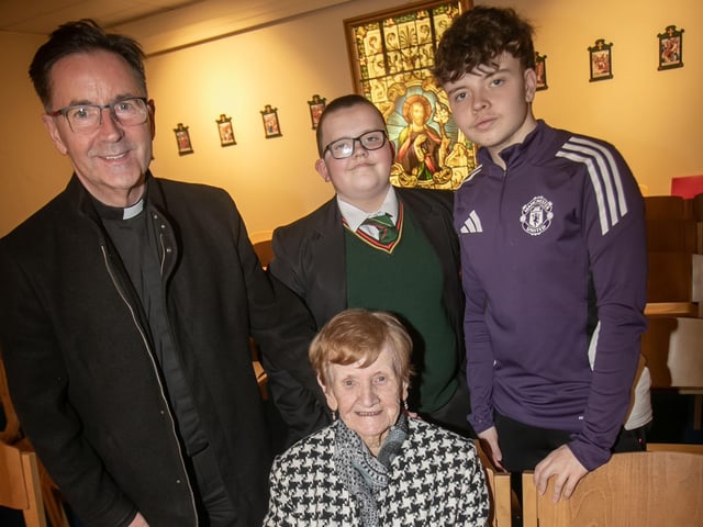 St. Joseph's Chaplain Fr. Shaun Doherty pictured with students Ben and Bobby and their grandmother. : .