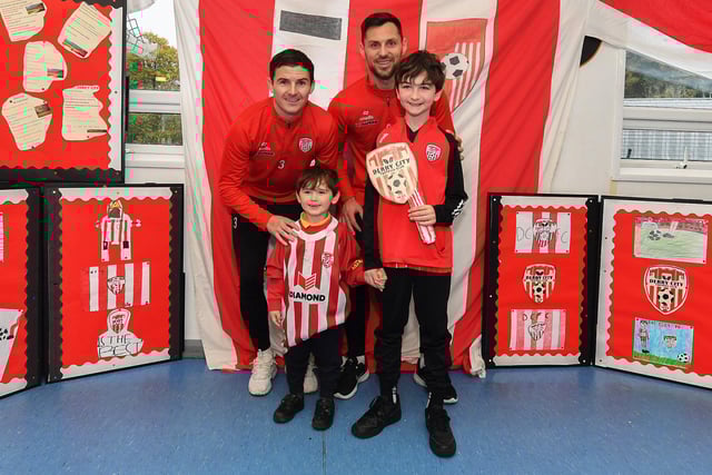 Pupils Sonny (Naiscoil) and Cohen (Rang 5), from Gaelscoil Eadain Mhoir, pictured with Derry City's Ciaran Coll and Pat Hoban during their visit to the school on Monday morning. Both pupils will be mascots for Friday evening's game against Shelbourne at the Brandywell. Photo: George Sweeney