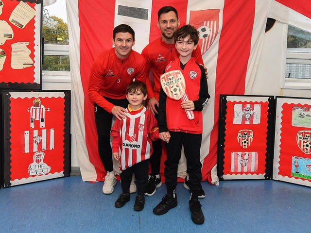 Pupils Sonny (Naiscoil) and Cohen (Rang 5), from Gaelscoil Eadain Mhoir, pictured with Derry City's Ciaran Coll and Pat Hoban during their visit to the school on Monday morning. Both pupils will be mascots for Friday evening's game against Shelbourne at the Brandywell. Photo: George Sweeney