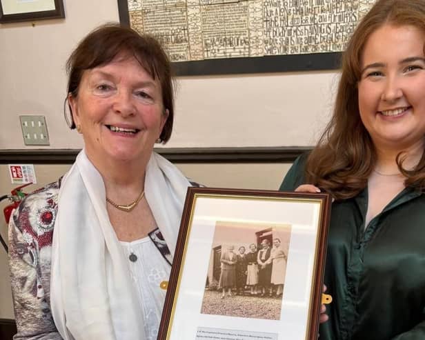 Dumfries Academy history teacher Heather Chalk and Deirdre McDowell holding a photograph of Jane Haining and family.