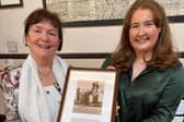 Dumfries Academy history teacher Heather Chalk and Deirdre McDowell holding a photograph of Jane Haining and family.