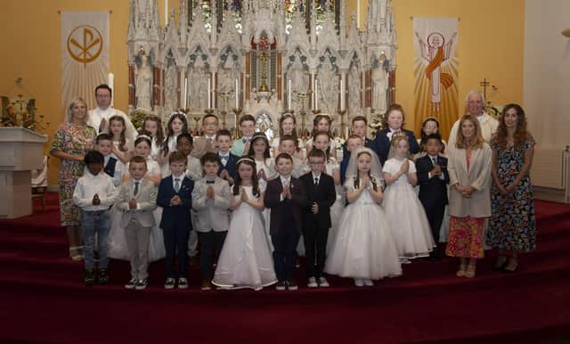 Pupils from Good Shepherd Primary School who received the Sacrament of First Holy Communion from Fr. Michael Canny at St. Columba’s Church, Waterside on Saturday last. Included in photo are Mrs. Suzann McCafferty, Principal, Deacon Sean Ward, Fr Michael Canny, Mrs R. Connor, teacher and Miss E. Donaghy, Learning Support Assistant. (Photos: Jim McCafferty Photography)