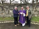 Fr. Francis Bradley P.P. receiving a cheque for €1860 from Malachy Harrigan . Also pictured is Kathleen Grant.