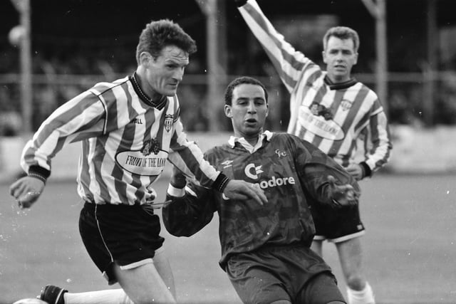Paul Hegarty shields the ball from Damian Matthew as Stuart Gauld looks on.