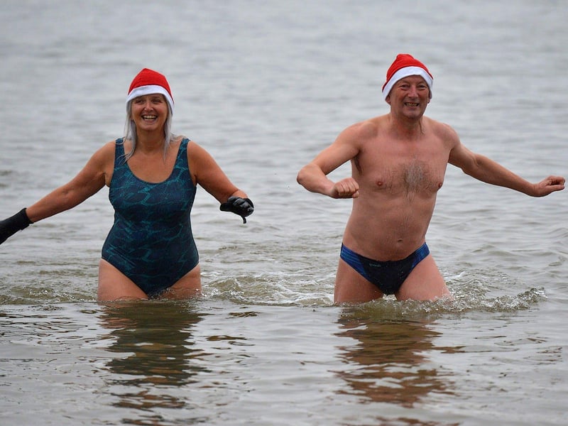 Swimmers brave the elements to take part in the annual Christmas morning charity swim at Ludden beach. Photo: George Sweeney. DER2252GS – 08