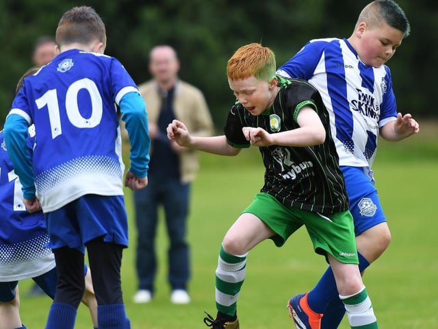 Top Of The Hill Celtic Colts under-10's player Mason Doherty tangles with Culmore Colts defender Corey Toland. (Photo: Keith Moore)