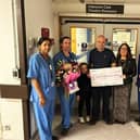 Relatives of Kevin Leonard handing over the donation.