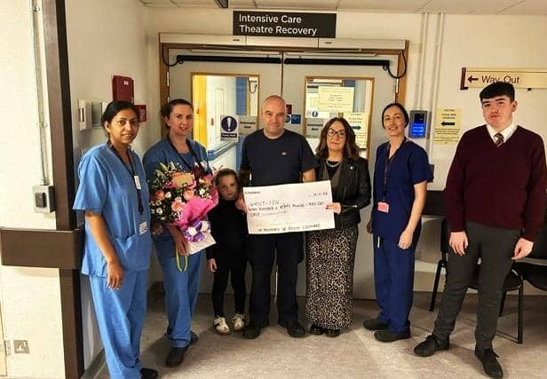 Relatives of Kevin Leonard handing over the donation.