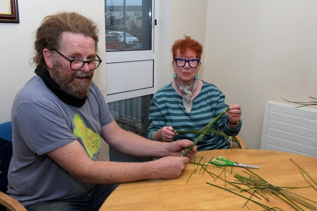 Patricia McAdams shows her completed St Brigids cross, weaved from rushes, to instructor Brendan Farren at Eden Place Arts Centre on Wednesday morning. Photo: George Sweeney