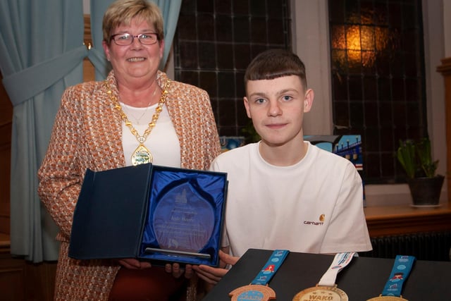 WELL DONE KYLE!. . . .The Deputy Mayor of Derry City and Strabane District Council, Angela Dobbins making a special presentation to Derry teenager Kyle Moore in recognition of his recent success in the WAKO World Championships in Italy and his gold medal success at the Bristol Open, during a reception in his honour at the Mayor’s Parlour, Guildhall on Thursday night last. (Photos: Jim McCafferty Photography)
