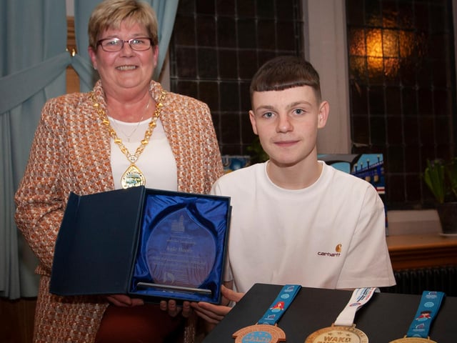 WELL DONE KYLE!. . . .The Deputy Mayor of Derry City and Strabane District Council, Angela Dobbins making a special presentation to Derry teenager Kyle Moore in recognition of his recent success in the WAKO World Championships in Italy and his gold medal success at the Bristol Open, during a reception in his honour at the Mayor’s Parlour, Guildhall on Thursday night last. (Photos: Jim McCafferty Photography)