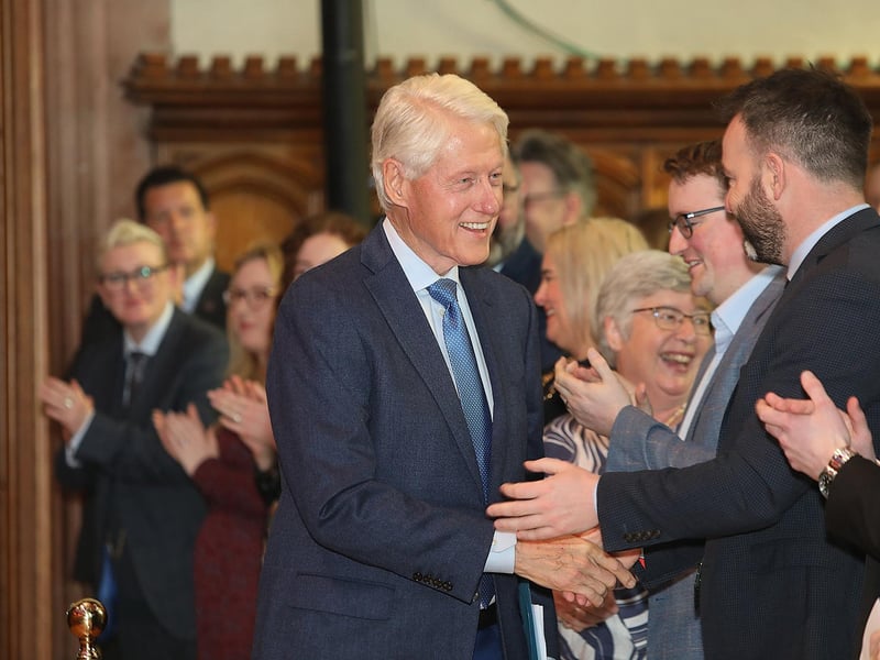 Bill Clinton is greeted by Colum Eastwood.