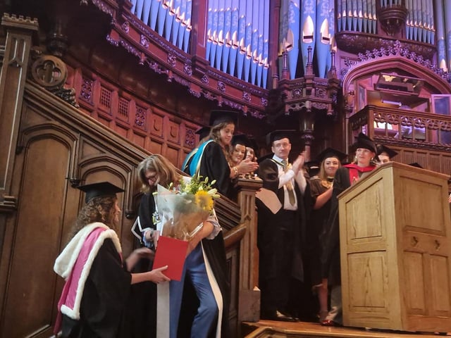 Professor Louise Dubras, Foundation Dean of the School of Medicine at Magee, receiving flowers from colleagues at the graduation ceremony for the first cohort of doctors to pass through the school.