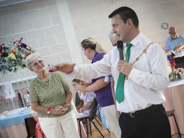The Mayor of Derry City and Strabane District Council, Ruairi McHugh making special praise to Sinead Devine and her DEEDS staff after the success of their Second Phase during Tuesday's Tea Party in Creggan.  : .